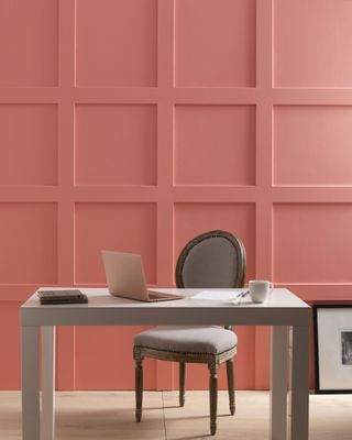 a pink room with paneling