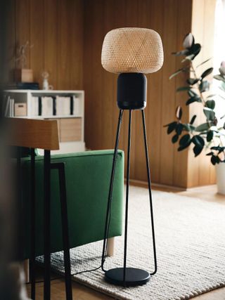 IKEA x Sonos SYMFONISK floor lamp speaker beside chair in living space