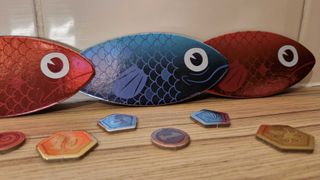 Closeup of fish tokens and points from Sounds Fishy