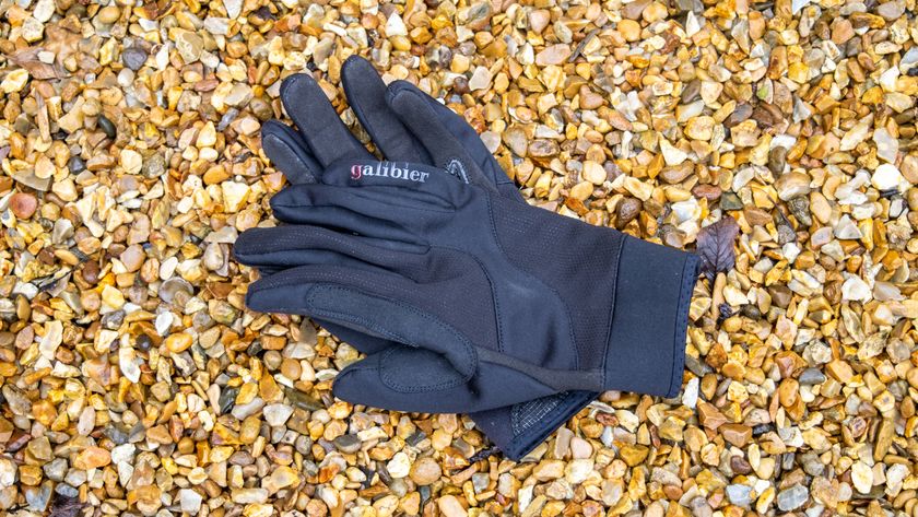 A pair of black Galibier Ardennes gloves on gravel 