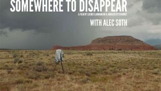 Camera tripod standing on a desert plain