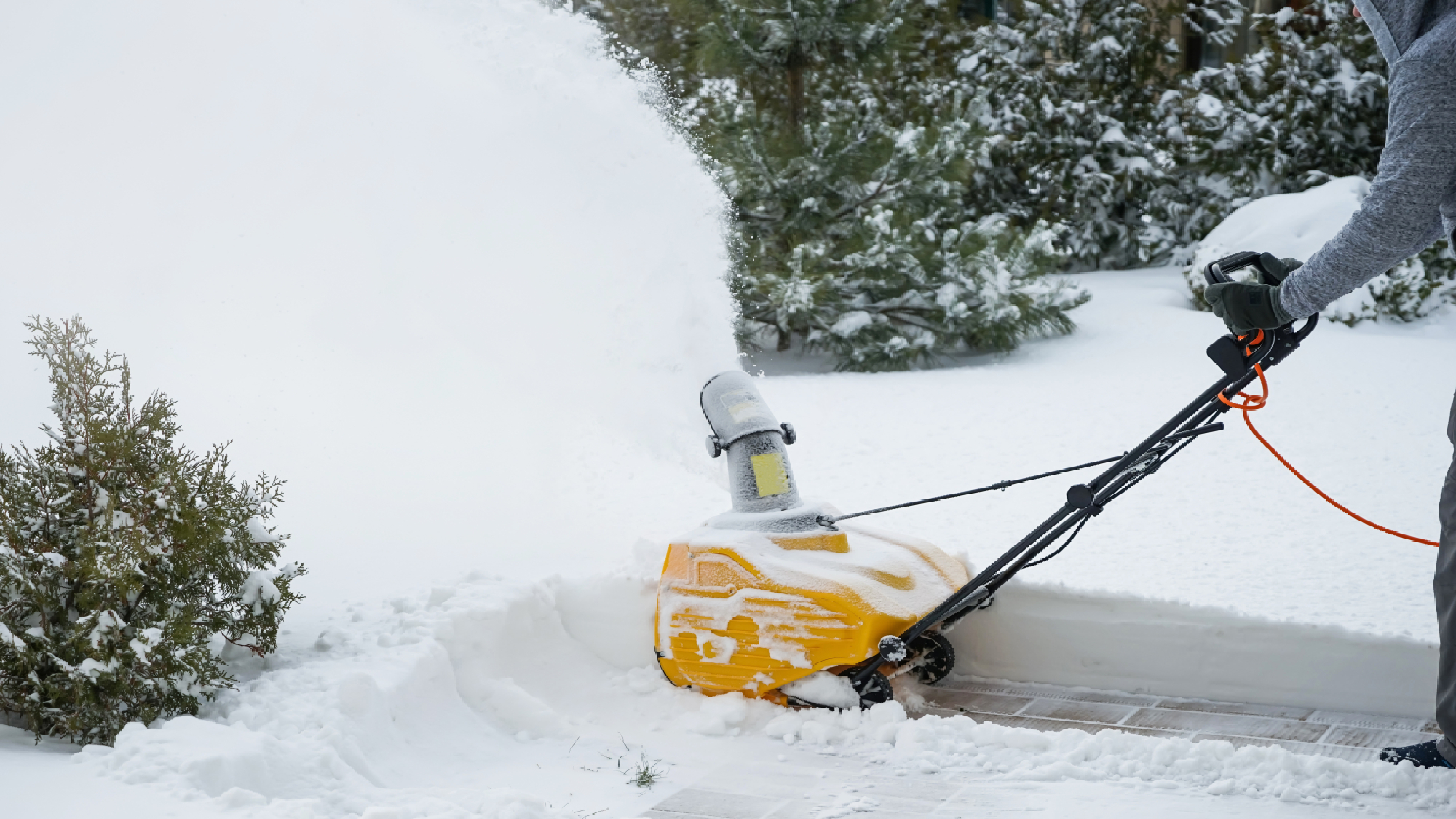 Person using electric snow blower