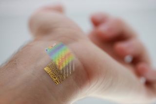 An ultrathin device for mapping changes in skin temperature to 0.02 °C is shown with a representative colormap of temperature distribution on the wrist