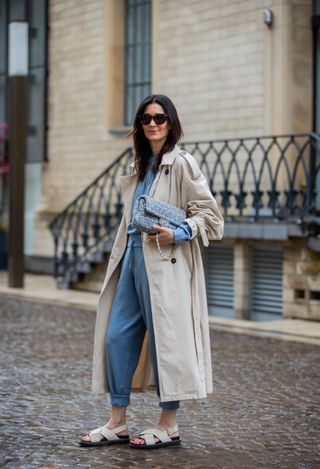 COLOGNE, GERMANY - MAY 21: Golestaneh Mayer-Uellner is seen wearing jogging suit Zara, trenchcoat H&M, dad sandals Marni, tweed bag Chanel in blue, sunglasses Celine on May 21, 2021 in Cologne, Germany. (Photo by Christian Vierig/Getty Images)