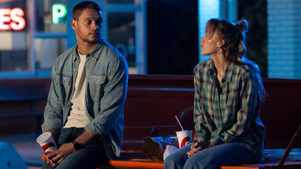 トラックの荷台に座って見つめ合うレジャーとケンナ。