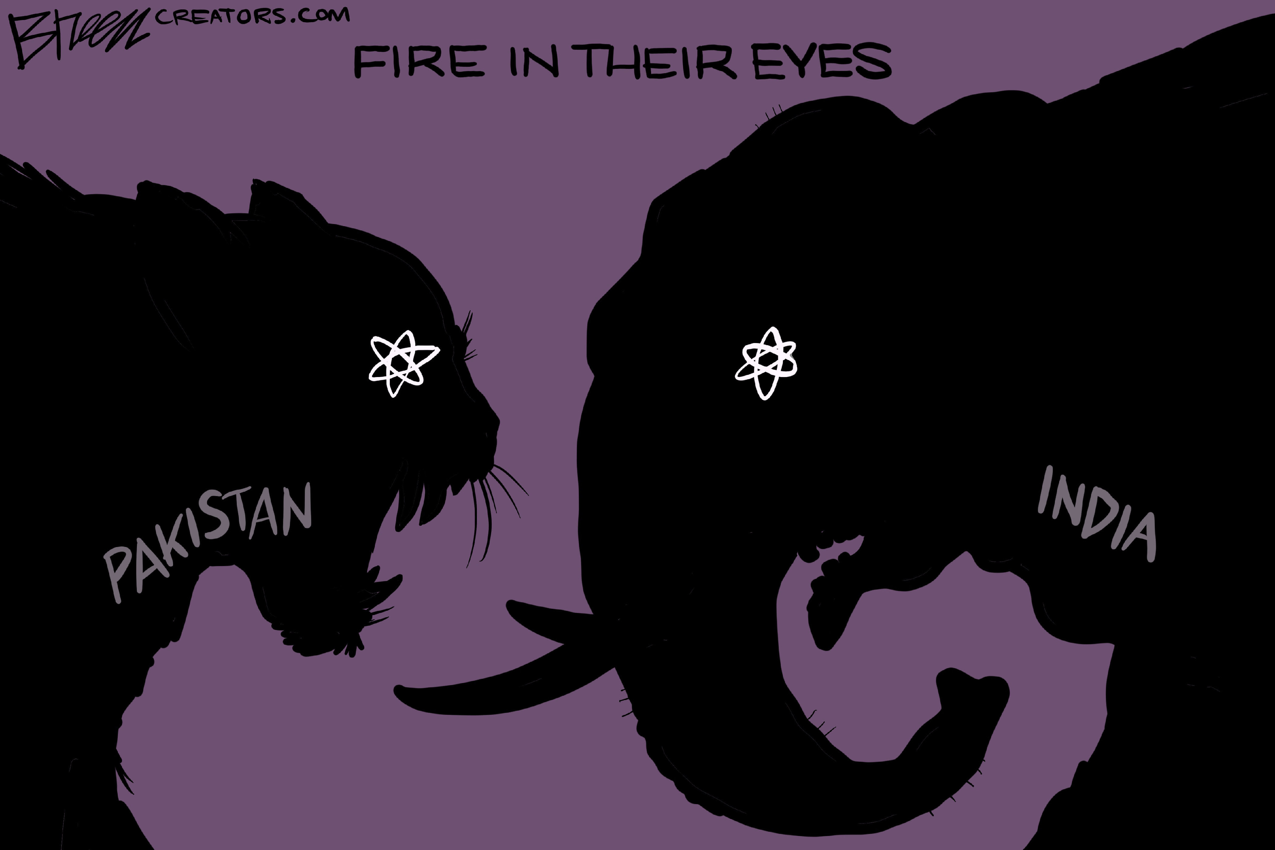 This cartoon, titled "FIRE IN THEIR EYES," depicts the silhouettes of two animal heads facing each other against a purple background. On the left is a tiger head, labeled "PAKISTAN," with glowing white atomic symbols in its eyes. On the right is an elephant head, labeled "INDIA," also with glowing white atomic symbols in its eyes.