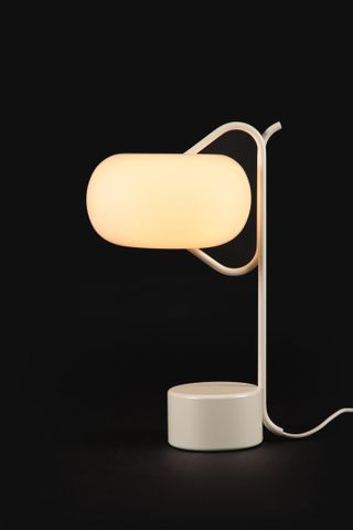A balloon-shaped white table lamp photographed on a black background, presented by Matter Made during New York Design Week 2021