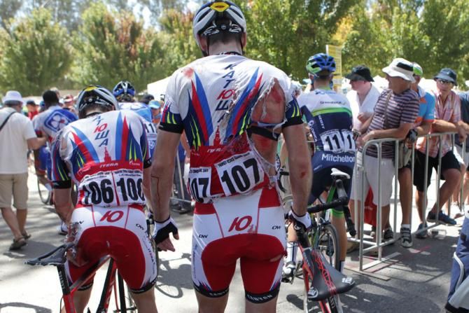 Katusha riders Aleksei Tcatevich and Vladimir Isaichev walk to the team pits after the mass crash in the last 300m of the stage