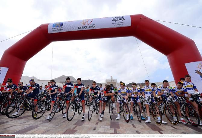 Riders bow their heads at the start in memory of Kristof Goddaert