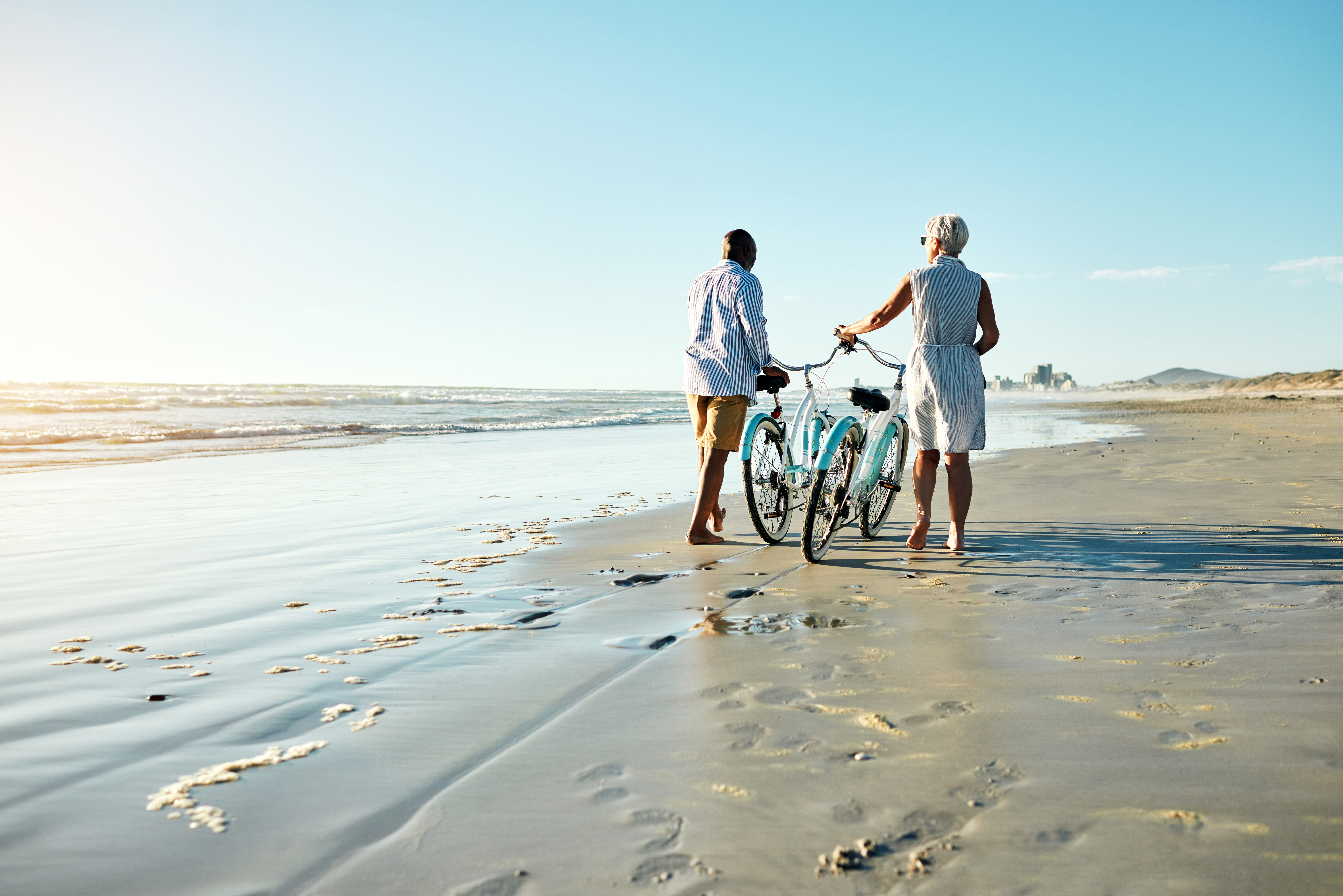 Couple on beach with a bike