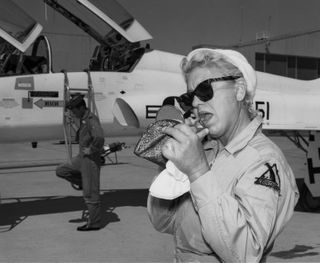 Jackie Cochran applying lipstick.