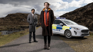 Sagar Radia (as DCI Ahmed Halim) and Sorcha Groundsell (Kat Crichton) star in "An t-Eilean/ The Island", the BBC's first Gaelic crime thriller.