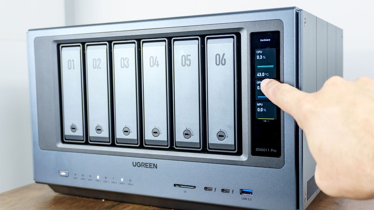 A person interacting with the touchscreen on the front of the Ugreen iDX6011 Pro