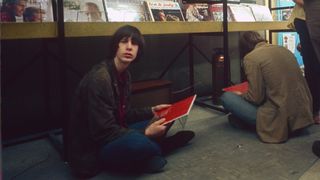 View of American Rock musician Todd Rundgren sits on the floor at the Record Mart, Philadelphia, Pennsylvania, June 1967. He holds a copy of the Beatles' 'Sgt PepperÕs Lonely Hearts Club Band' album, which had just been released.