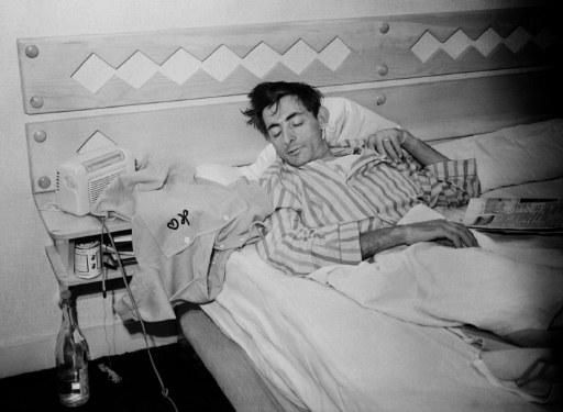 Coppi has a sleep next to his yellow jersey during a rest day at the 1952 Tour de France
