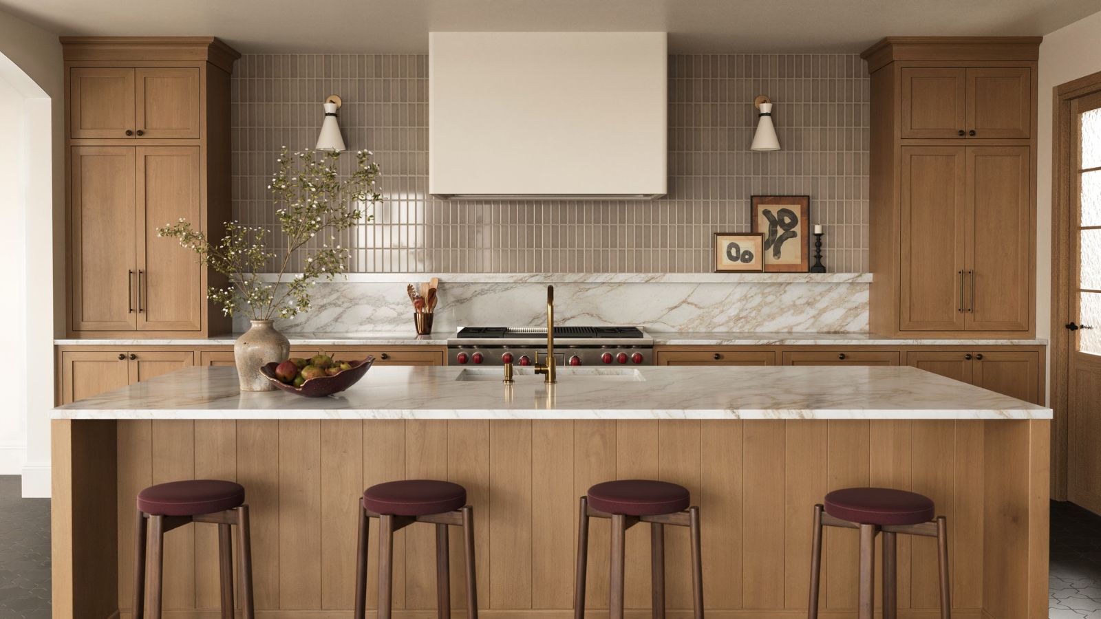 A wooden kitchen with a marble countersplash that flows into warm neutral wall tiles