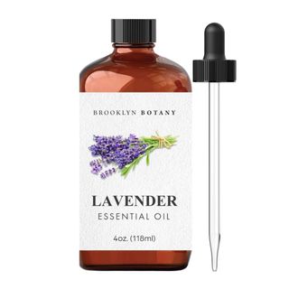 A brown bottle of lavender essential oil with a pipette next to it