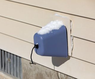 Faucet cover covered in snow