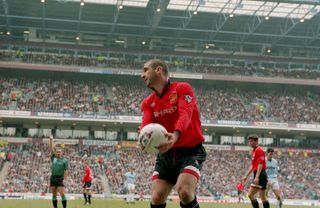 Eric Cantona in action for Manchester United against Manchester City at Maine Road in April 1996.