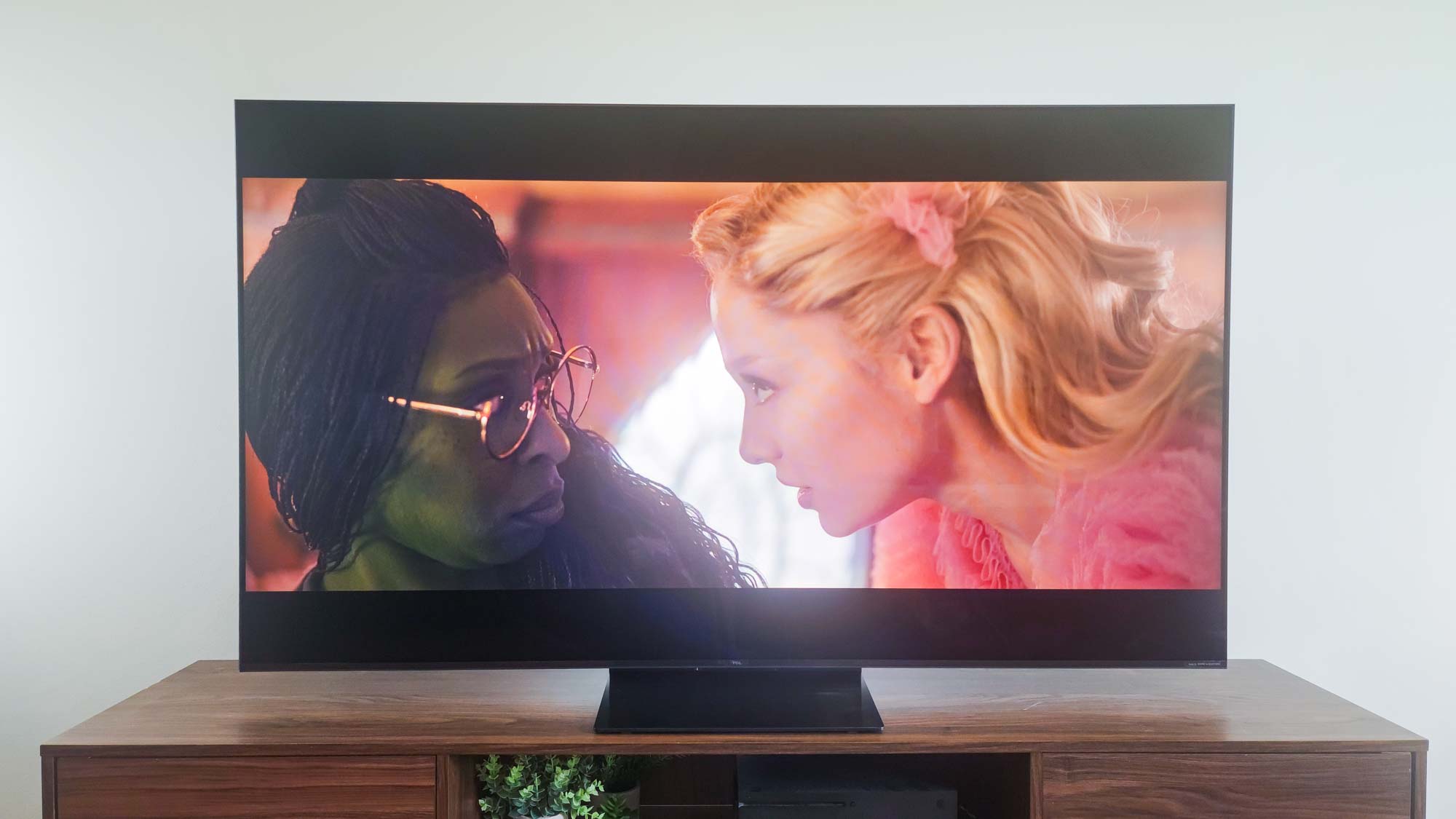 A TCL QM7K QD-Mini LED TV on a side table