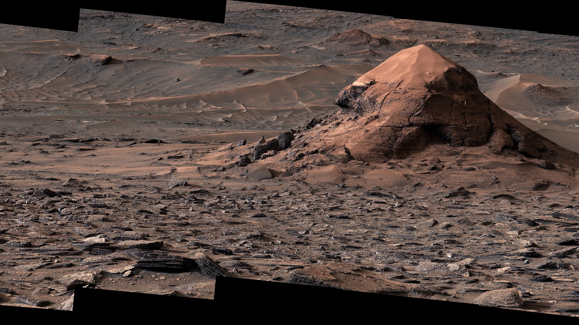 a reddish-brown landscape of soil and rocks covered in slightly raised hexagonal lines of nearly equal size