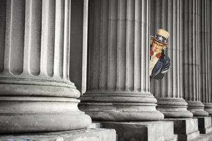 Uncle Sam peeks out from courthouse columns
