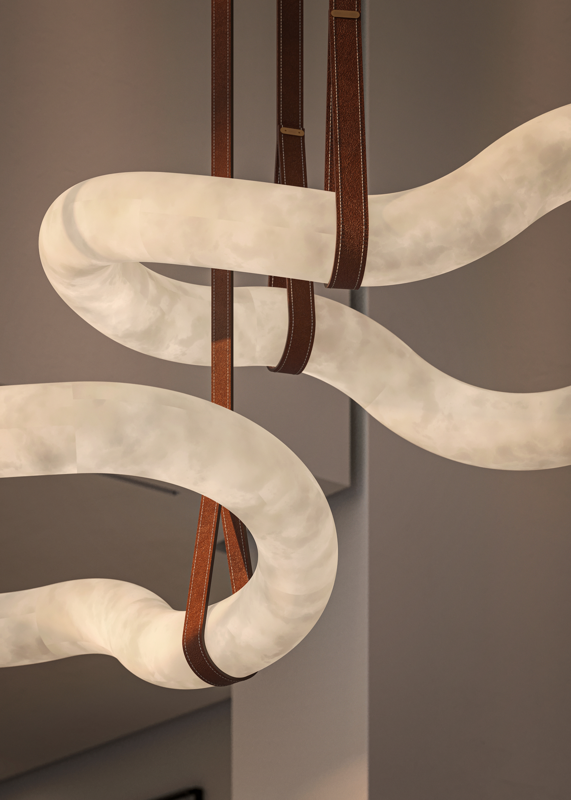 close up of glass and leather lighting in sinuous shapes