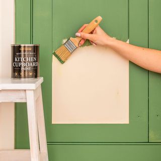 paint brush with white stool and green painted cupboard