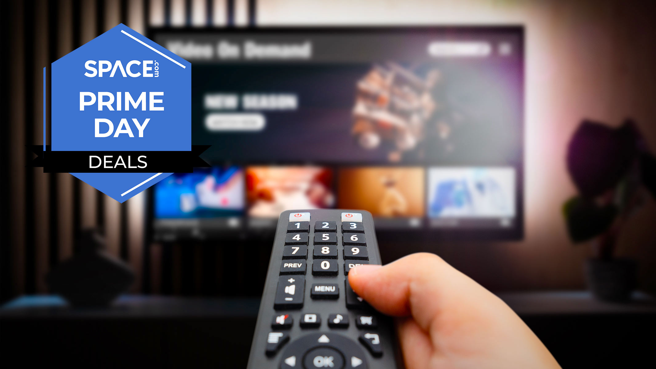 A remote controller is being held by a hand in front of a TV with the space.com logo in the top left corner.