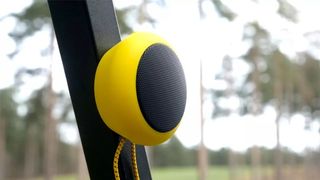 The TecTecTec Team8 GPS Speaker clipped onto the side of a golf buggy
