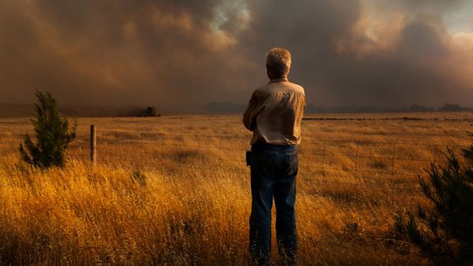 A man watches a bushfire. Wildfires and other disasters will increase, a UN report predicts.