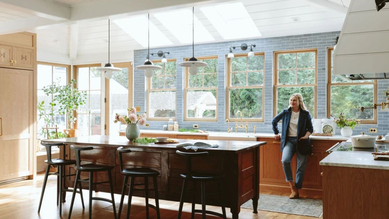 Vintage kitchen with wood paneling, wood kitchen island, pendant lighting and Emily henderson