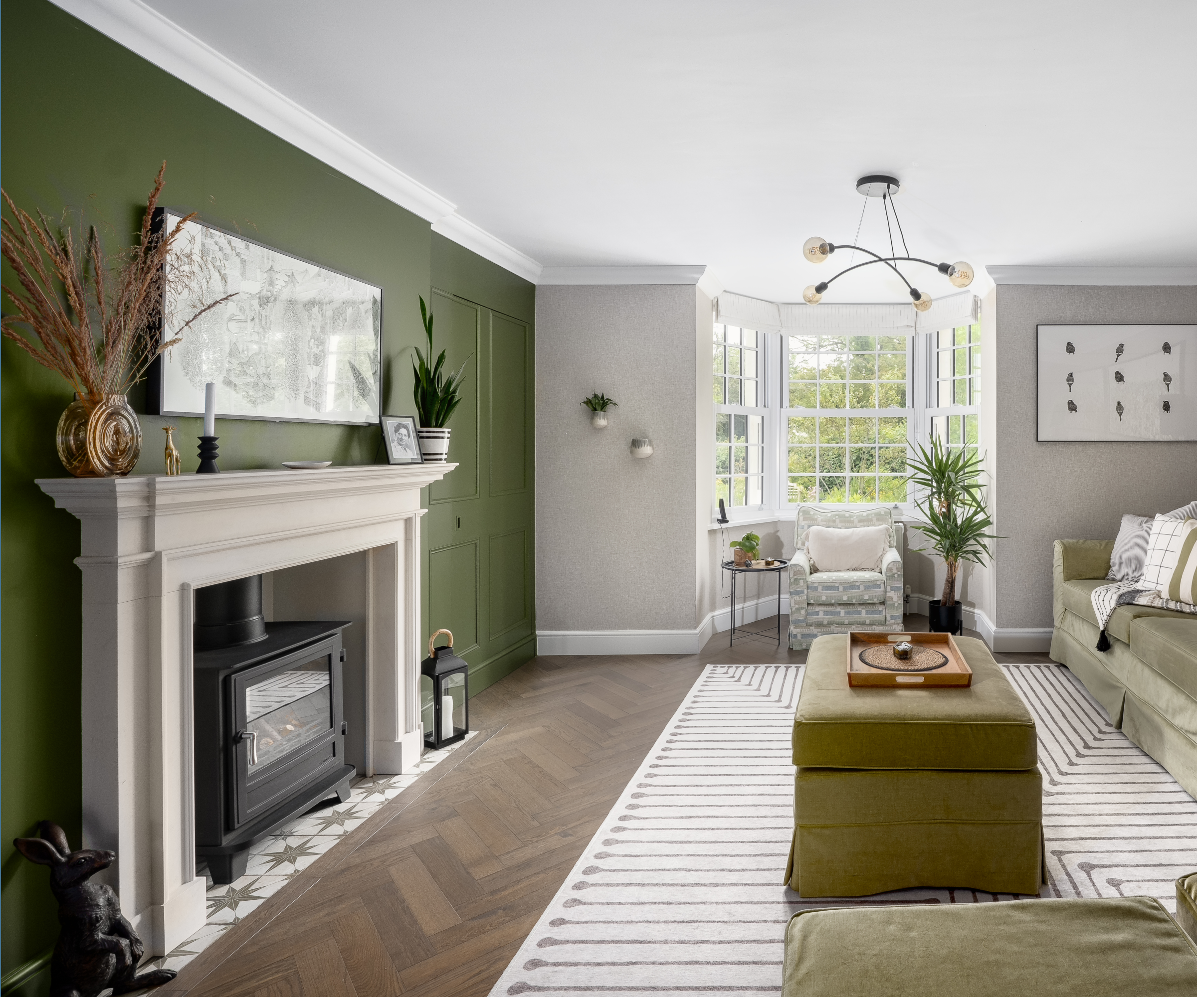 Living room with green fireplace feature wall
