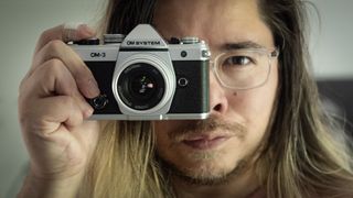 OM System OM-3 being held by photographer James Artaius