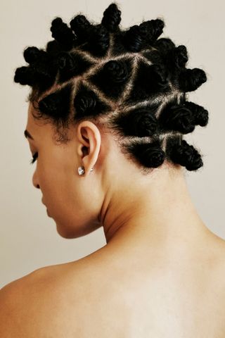 A woman pictured with mini braided buns