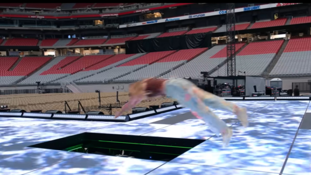 Taylor Swift diving into her stage.