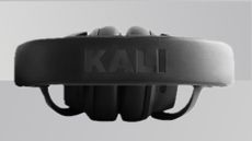 A product shot of the Kali Audio HP-1 headphones from above against a gradient grey background