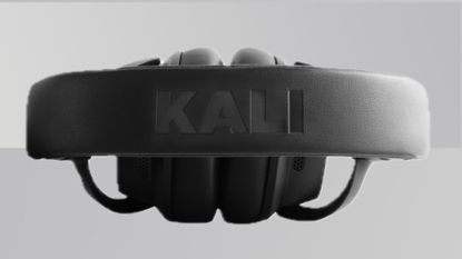 A product shot of the Kali Audio HP-1 headphones from above against a gradient grey background
