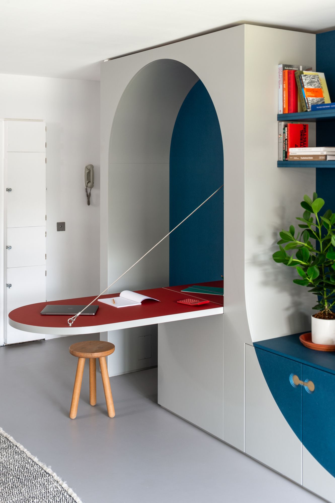 Curved fold-down desk with red top