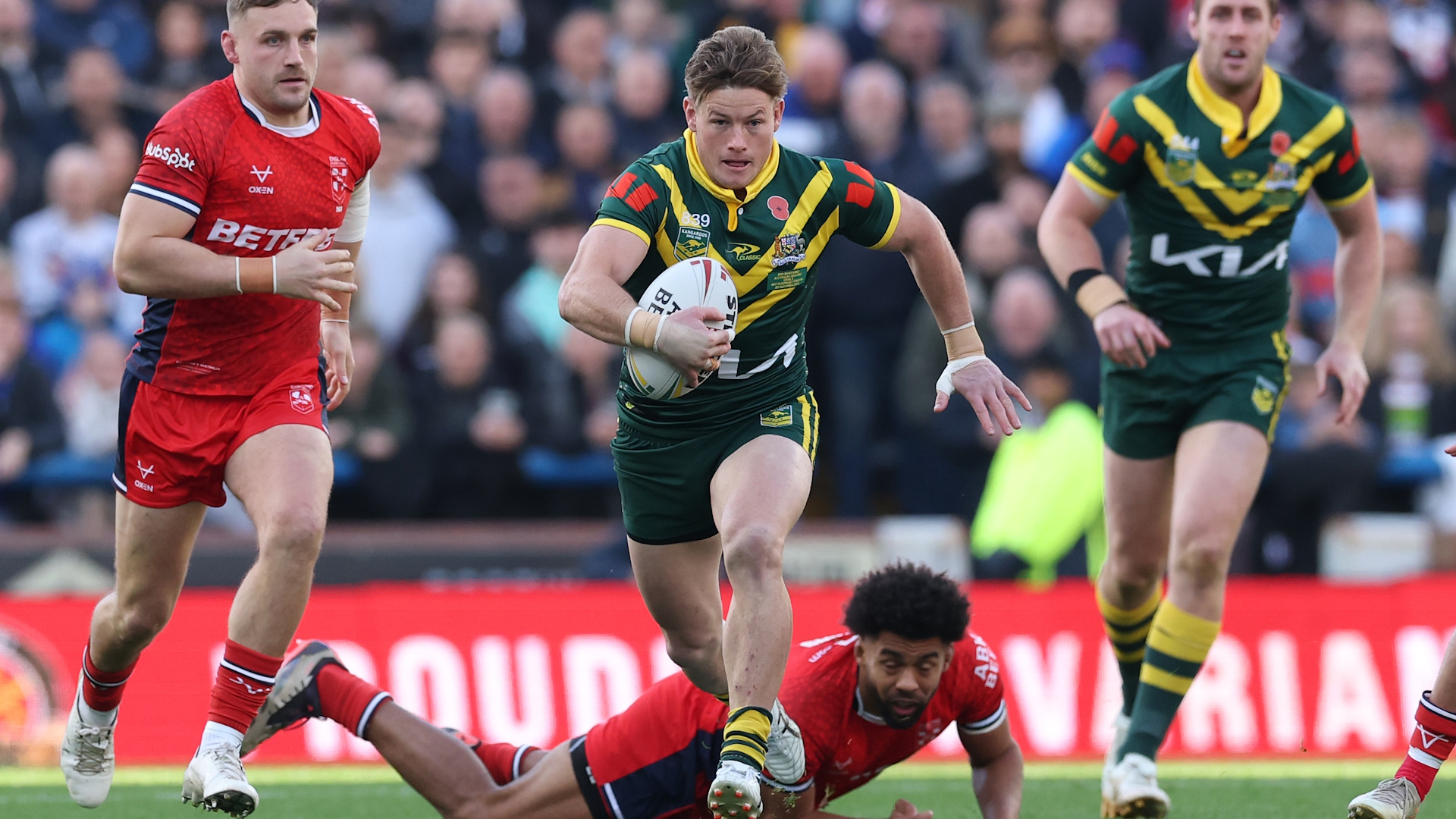 Harry Grant of Australia bursts past England's defense during a rugby league match.