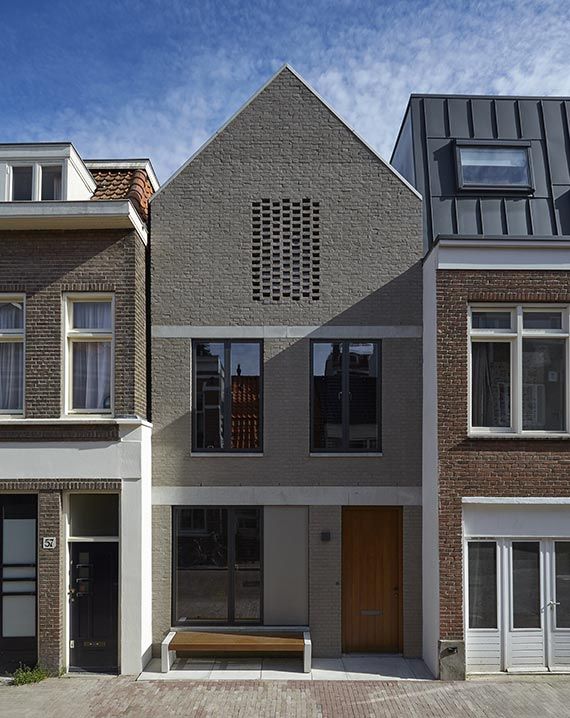 Grey sloping roof house with white windows