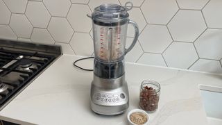 Breville the Fresh & Furious on a kitchen countertop with crushed nuts