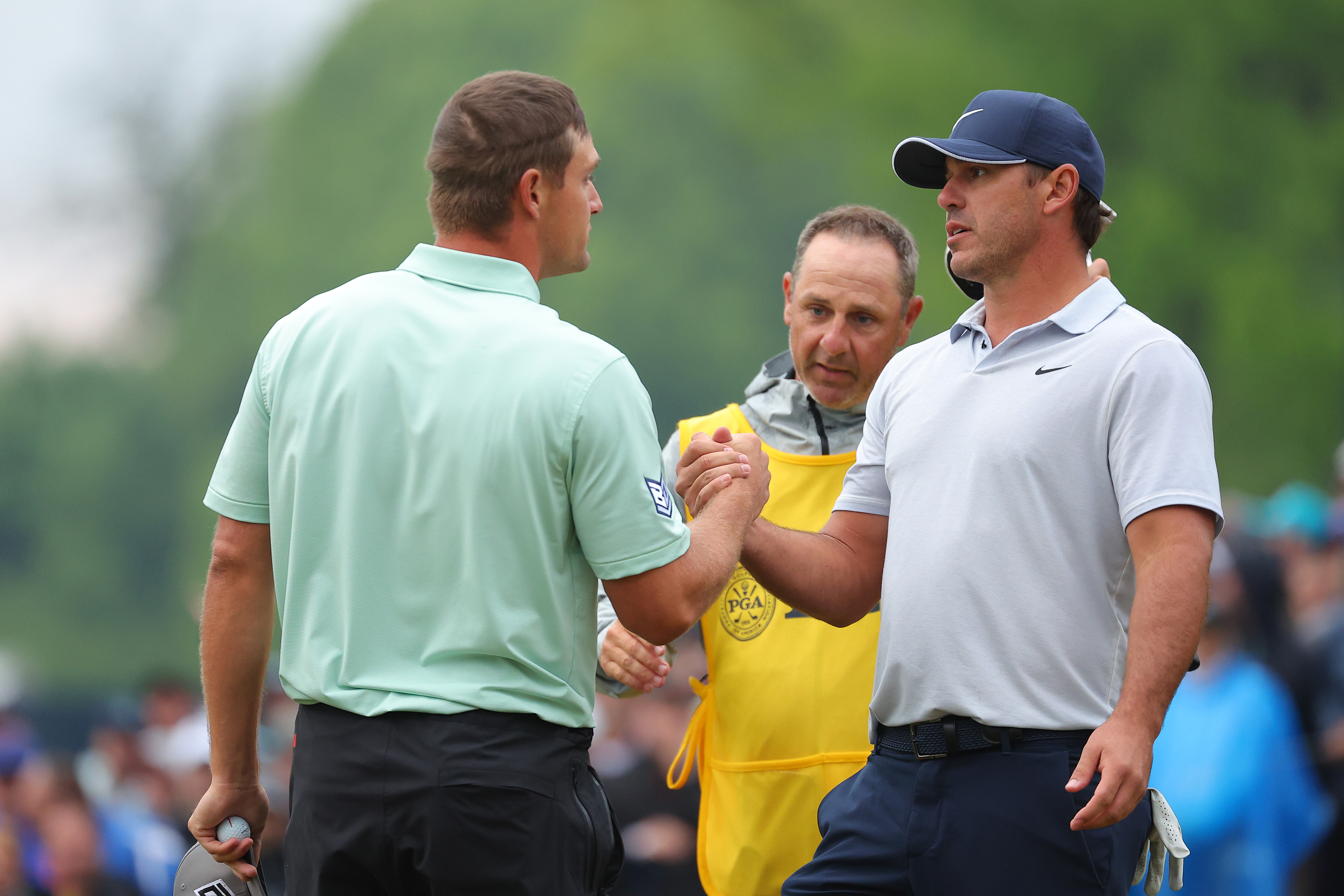 Bryson DeChambeau and Brooks Koepka shake hands