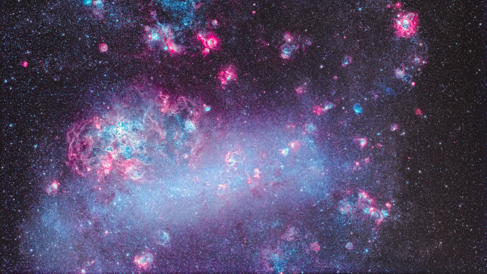 A cloud of purple and pink dust and lights swirls in the darkness of space