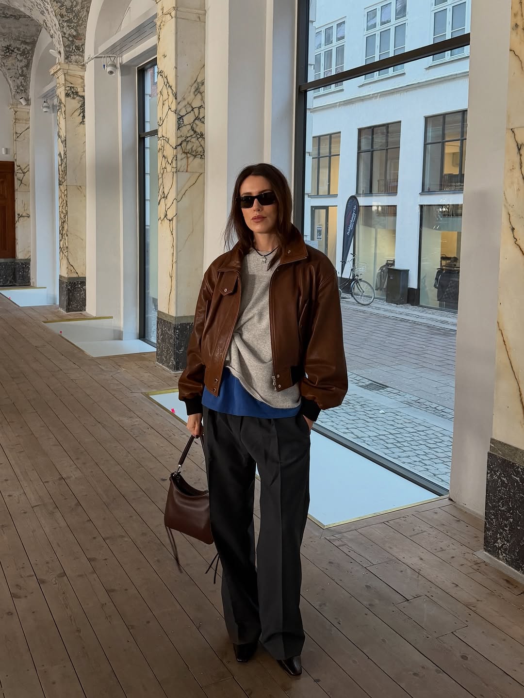 Woman wearing layering outfit idea 2026.