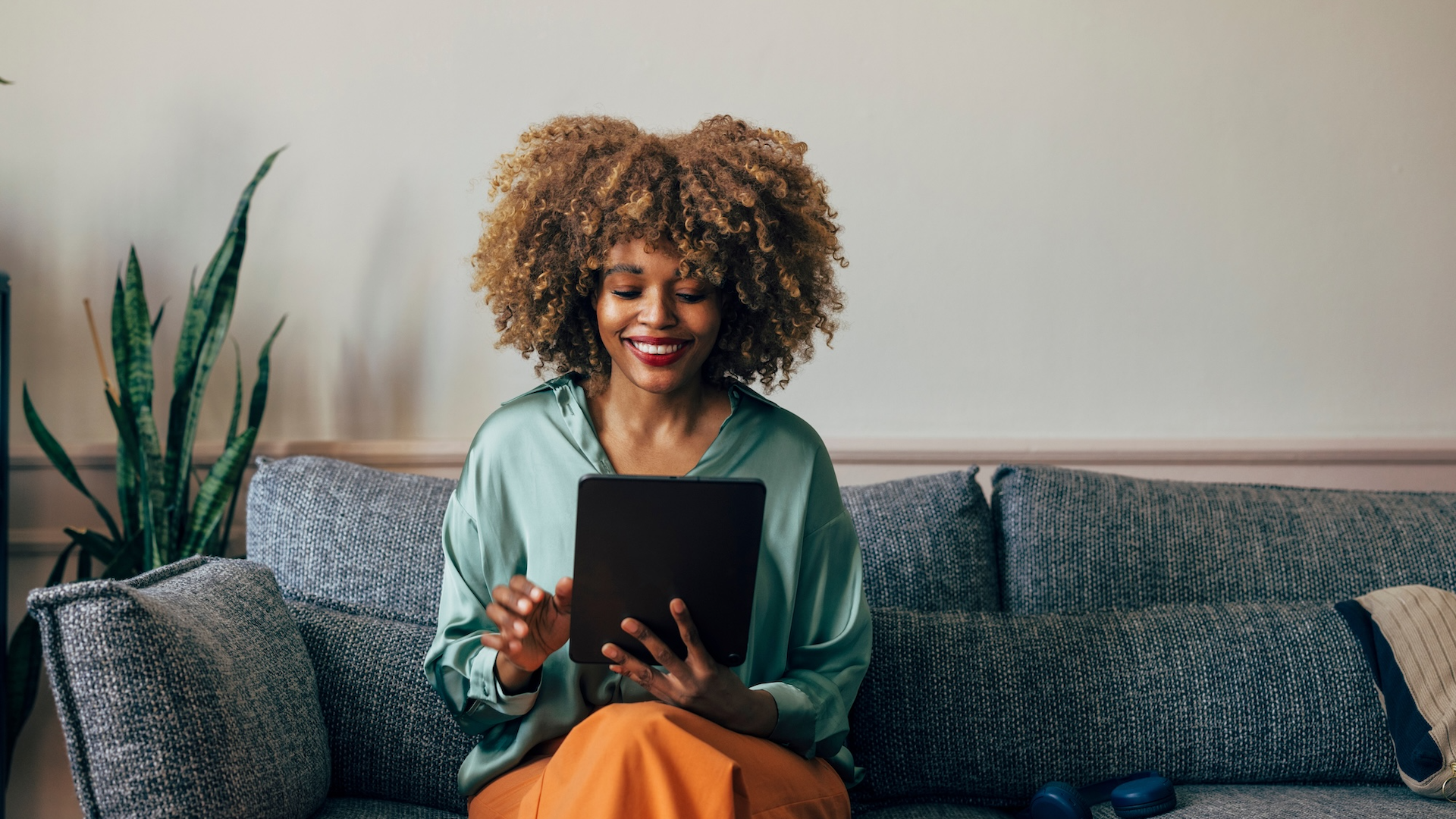 Woman looking at tablet on sofa