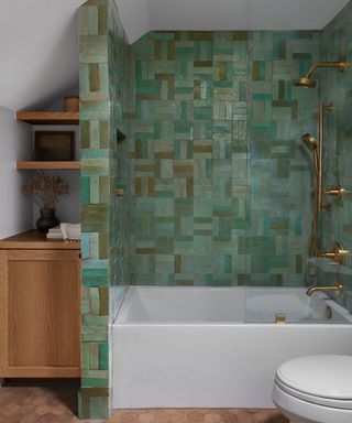 A bathroom with blue and green basketweave tile