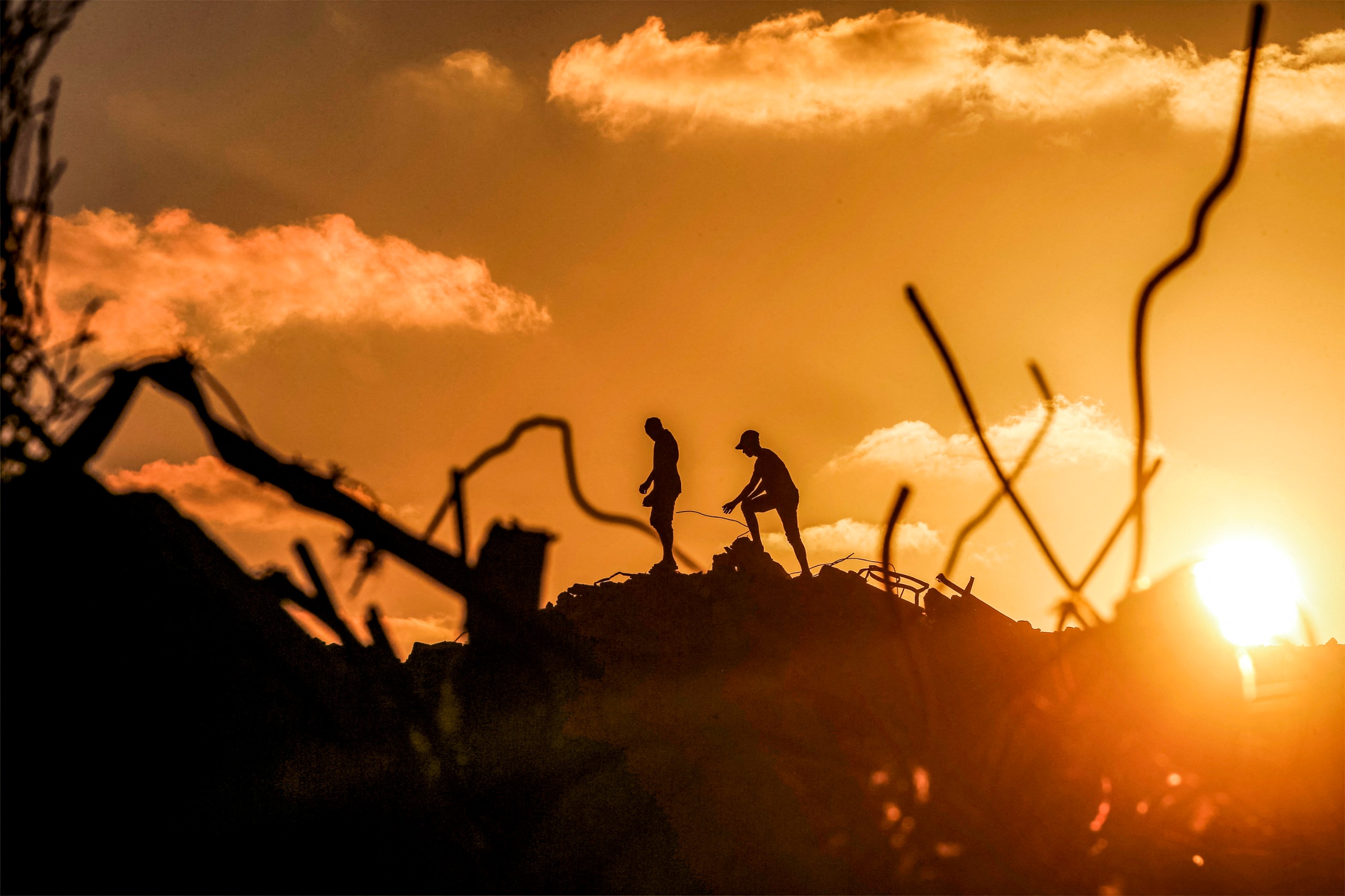 Men walk through rubble at the Bureij camp for Palestinian refugees in the central Gaza Strip on September 14, 2026