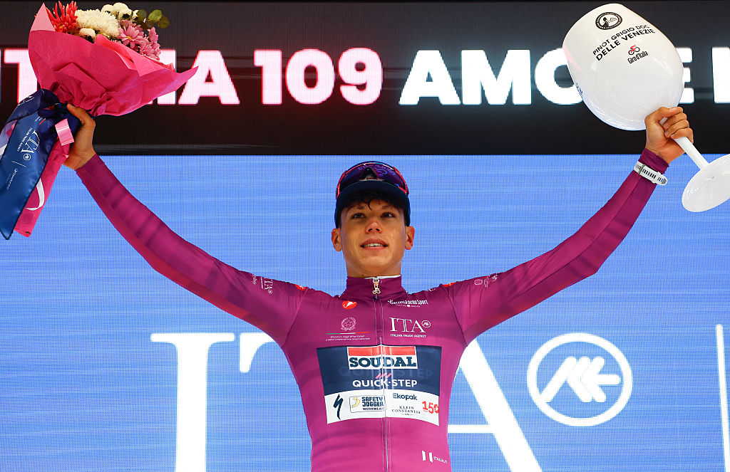 Soudal Quick-Step French rider Paul Magnier wearing the points classification mauve jersey (Maglia Ciclamino) celebrates on the podium after the 2nd stage of the Giro d'Italia 2026 - Tour of Italy cycling race between Burgas and Veliko Tarnovo, Bulgaria, on May 9, 2026. (Photo by Luca Bettini / AFP)