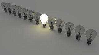 Lightbulbs in a row with only one lit - competition with energy industry giants